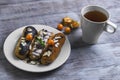 Cakes eclairs, mint, berries Physalis