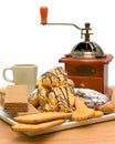 Cakes, pastries, coffee cup and coffee grinder