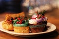 cakes on a plate - cupcakes and eclairs, close up Royalty Free Stock Photo