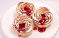Cakes of puff pastry and apples on a table similar to roses with raspberry syrup Royalty Free Stock Photo