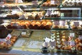 Cakes in showcase. Italian pastry shop with different baba, donuts, jelly, ice cream, cakes with fruits. Royalty Free Stock Photo