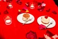 Cakes in white plates on a red tablecloth Royalty Free Stock Photo