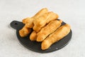 Cakwe or Cakue or Youtiao is traditional Chinese snack, long golden-brown deep-fried strip of dough. Royalty Free Stock Photo