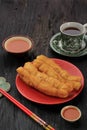 Cakwe or Chinese Oil Bread  Stick is Indonesian Traditional Food for Breakfast Served in Ceramic Plate on Wooden Table. In Royalty Free Stock Photo