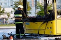 Cal fire firefighter using axe while extinguish bus fire