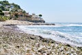 Cala Baladrar empty pebble stone beach. Costa Blanca, Spain