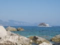 Cala Goloritze, Sardinia, Italy, September 8, 2020: A view of tourist cruise ship at turquoise blue water of Gulf of