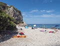 Cala Gonone, Sardinia, Italy, September 9, 2020: Cala Fuili beach with sunbathing people and tourists. White pebbles