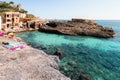 Cala s`Almunia, Majorca, Spain - August 7, 2020: Natural cove with transparent waters called Cala s`Almunia with fishermen`s house