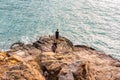 3 youngs stay in the rock in winter in Cala Salada in San Antonio Abad Royalty Free Stock Photo