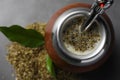 Calabash with mate tea and bombilla on light grey table, closeup. Space for text Royalty Free Stock Photo
