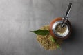 Calabash with mate tea and bombilla on light grey table, flat lay. Space for text Royalty Free Stock Photo