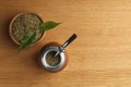 Calabash with mate tea and bombilla on wooden table, flat lay. Space for text Royalty Free Stock Photo