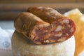 Calabrese soppressata laid on a whole cheese Royalty Free Stock Photo