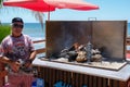 CALAHONDA, ANDALUCIA/SPAIN - JULY 2 : Man Cooking Sardines on th