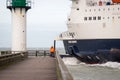 Calais Seaways Ferry going out at from the Port of Calais. Fisherman catches fish from the pier at the lighthouse