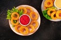 Calamari rings. Deep fried squid rings with various dips, overhead flat lay shot Royalty Free Stock Photo