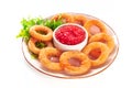 Calamari rings, isolated. Deep fried squid rings with green salad leaves