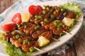 Calamari rings on skewers with lemon and vegetables closeup. horizontal Royalty Free Stock Photo