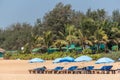 A beach shack with chairs and umbrellas outdoor in the sand at a popular beach in North Goa Royalty Free Stock Photo