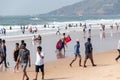 A lifeguard carrying lifejackets at the crowded tourist beach in Calangute in North Goa