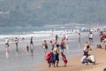 A lifeguard carrying lifejackets at the crowded tourist beach in Calangute in North Goa