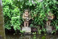 Huge concrete carved Statue of pacific islander man holding fish in jungle