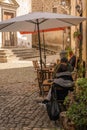 People in cafe on square in Calcata Vecchia. Second wave of coronavirus covid19, non-observance of social distance