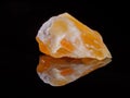 Calcite orange close-up. Black background. Macro image.