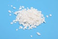 Calcium chloride on blue background Royalty Free Stock Photo