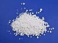 Calcium chloride on blue background Royalty Free Stock Photo