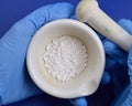 Calcium chloride on blue background Royalty Free Stock Photo