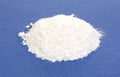 Calcium citrate powder on blue background.