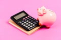 Calculate profit. Piggy bank pink pig and calculator. Economics and finance. Credit concept. Money saving. Save money