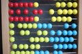 Calculating with beads on wooden rainbow abacus for number calculation. Mathematics learning concept Royalty Free Stock Photo