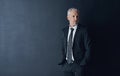 Calculating his next business move. Studio shot of a mature businessman against a dark background.