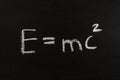 The calculation for mass energy equivalence ist standing on a chalkboard, physic formular Royalty Free Stock Photo