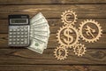 Calculator, American dollar banknotes of currency signs, businessman runs in gears