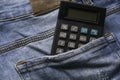 Calculator at the back pocket of blue jeans Royalty Free Stock Photo