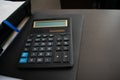 Calculator on black folder on desktop Royalty Free Stock Photo