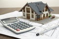 Calculator and blueprint with villa house model Royalty Free Stock Photo
