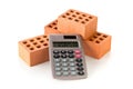 Calculator with bricks on white, real estate or house building costs concept Royalty Free Stock Photo