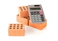 Calculator with bricks on white, real estate or house building costs concept Royalty Free Stock Photo