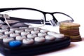 Calculator, coins and glasses Royalty Free Stock Photo