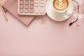Calculator, a cup of coffee with a beautiful pattern and a notepad on a pink background. Place for text Royalty Free Stock Photo