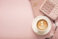 Calculator, a cup of coffee with a beautiful pattern and a notepad on a pink background. Place for text Royalty Free Stock Photo