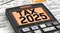 Calculator displaying tax information for the year 2025 on financial documents