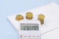 The calculator displays 123456789 on the background of the calendar and coins.Business and tax concept. Pay tax