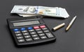 Calculator with dollar bills and pen on black Royalty Free Stock Photo