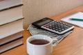 Calculator, dollars, notepad and books on the table Royalty Free Stock Photo